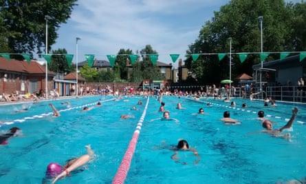 Londoners enjoy a swim in London Fields, Hackney.