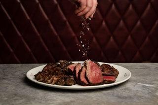 Glowing neon and counter seating that puts you just inches away from the kitchen action make this hidden gem within...